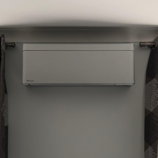 Daikin Stylish grey AC install in a residential bedroom